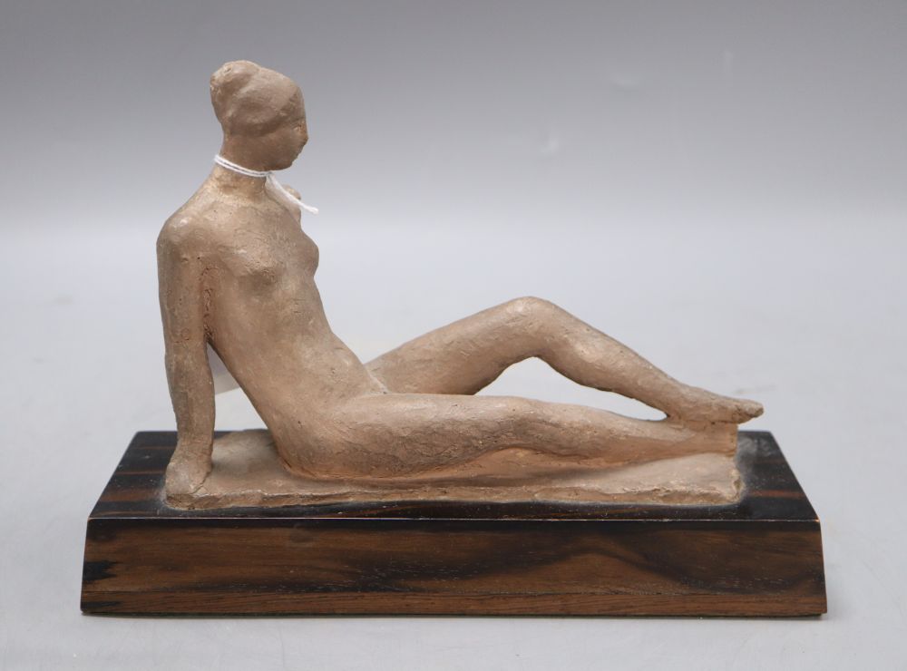 A terracotta maquette of a reclining nude, on coromandel plinth, height 17cm width 23cm